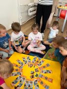 dzieci siedzą wokół ułożonego słońca