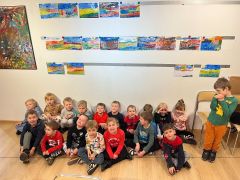 Dzieci pozują ze swoimi obrazami