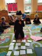 Dziewczynka stoi nad rozłożonymi białymi kartami do wróżby.